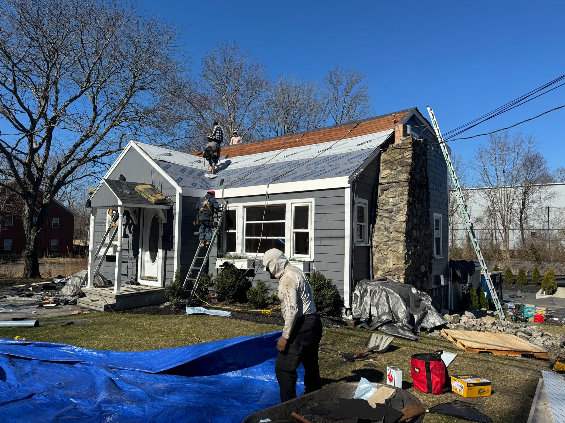 A man is standing in front of a house that is being remodeled