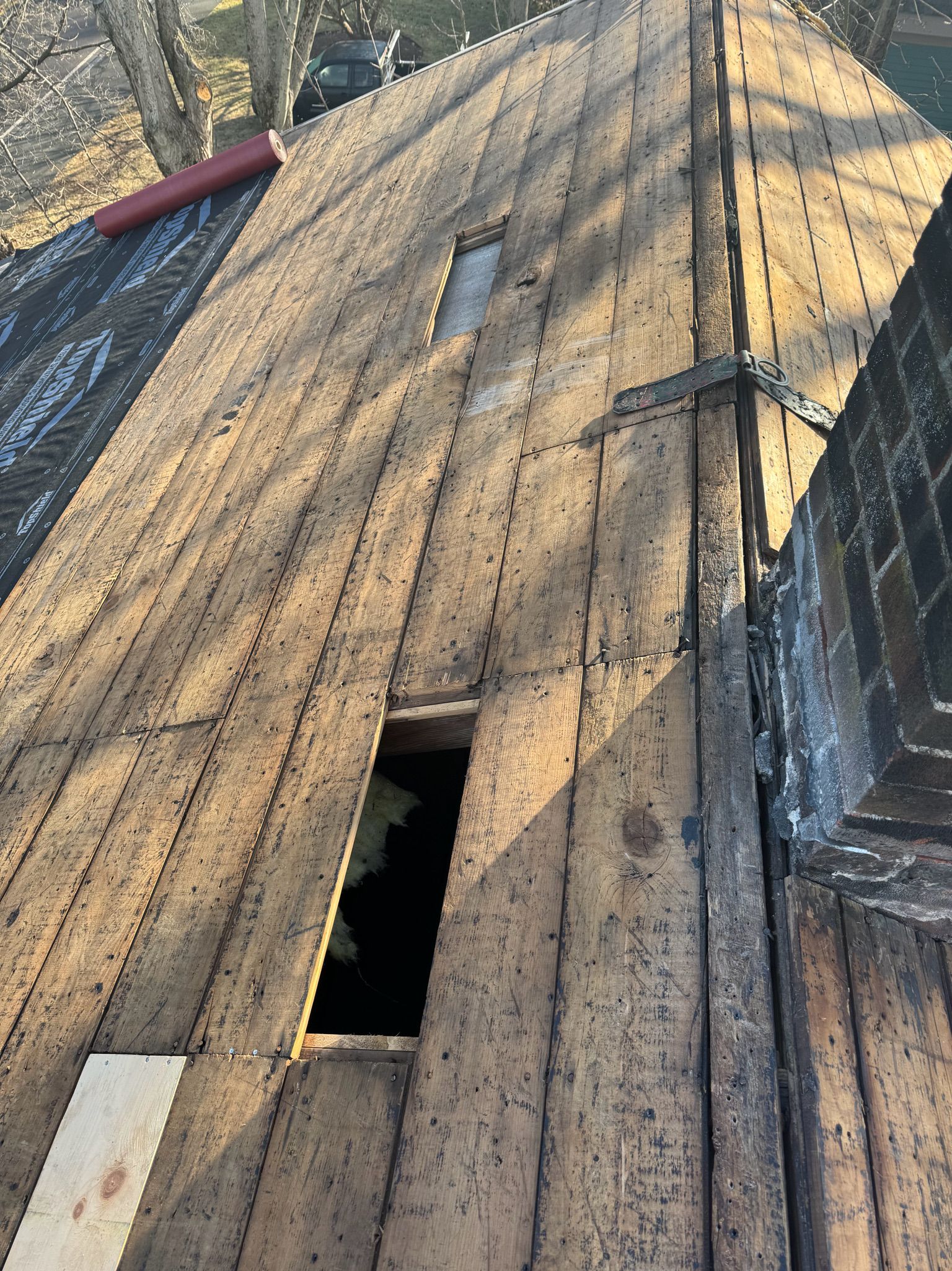 A wooden roof with a hole in it and a chimney