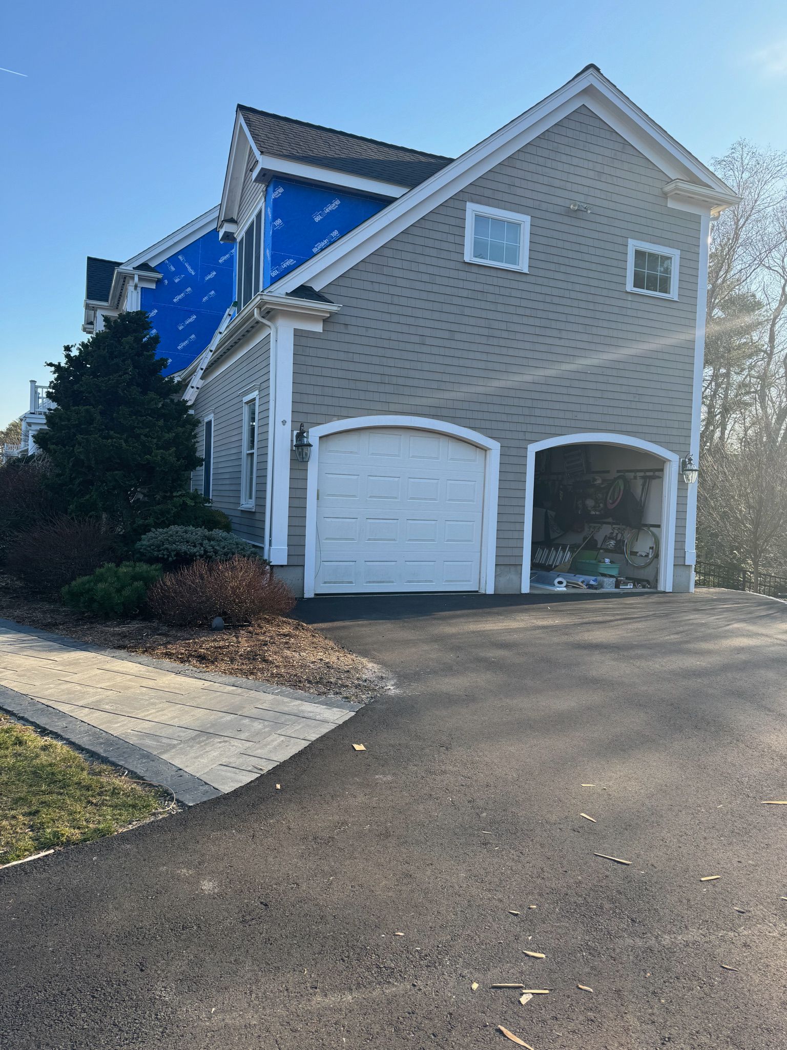 A house with a garage and a driveway in front of it