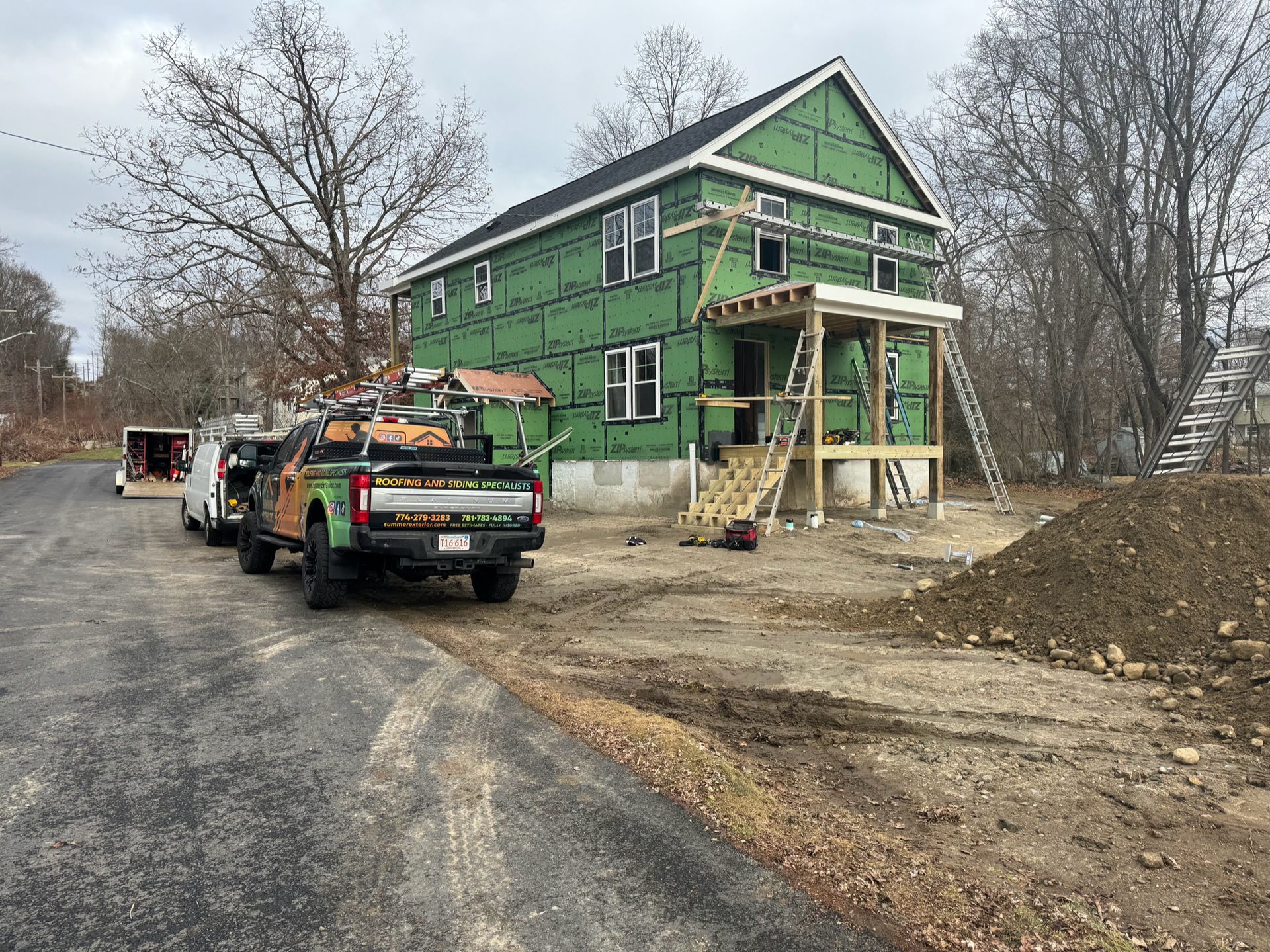 A truck is parked in front of a house under construction