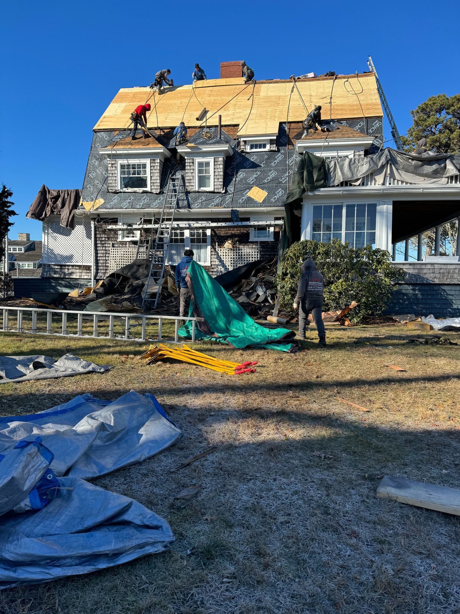 A house is being remodeled with a roof being installed
