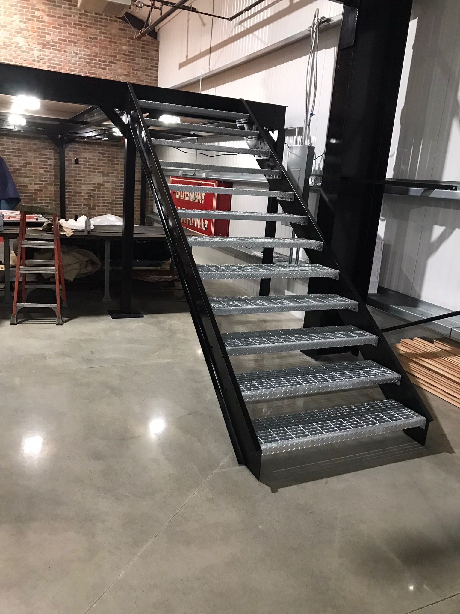 Black metal staircase in an industrial warehouse interior