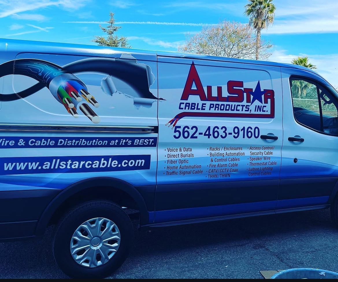 Blue service van with AnStar Cable Products logo, phone number, and website parked outdoors