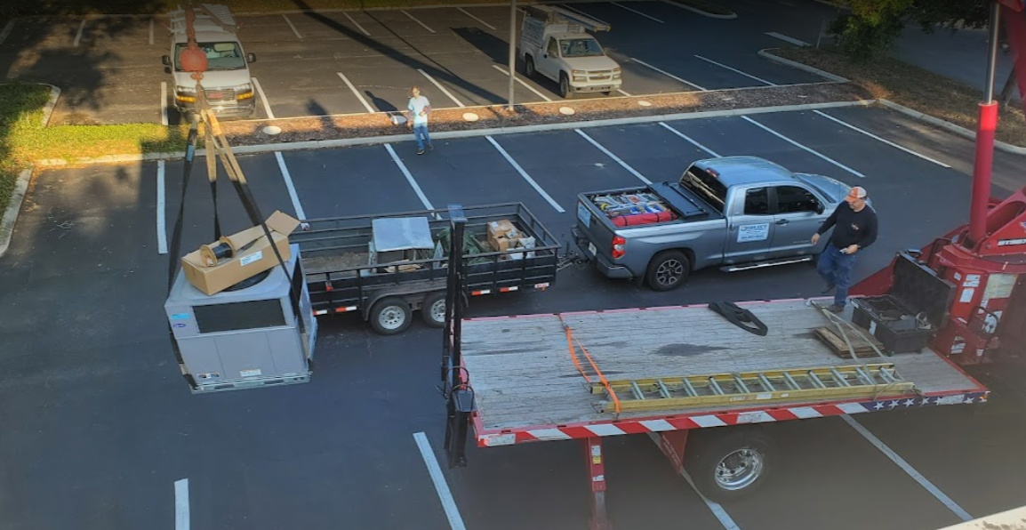 pick up truck and commercial hvac being pulled up