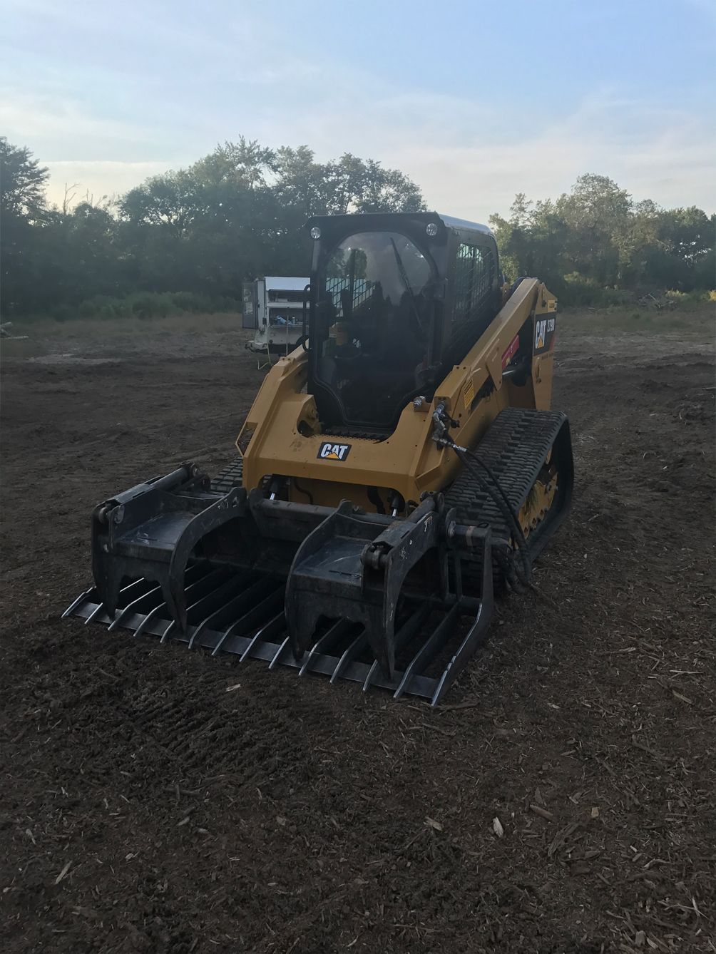 A bulldozer is parked in a dirt field.