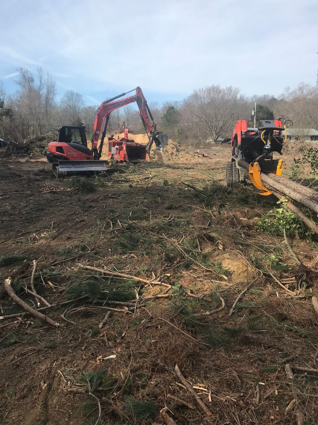 A couple of tractors are sitting in a field.
