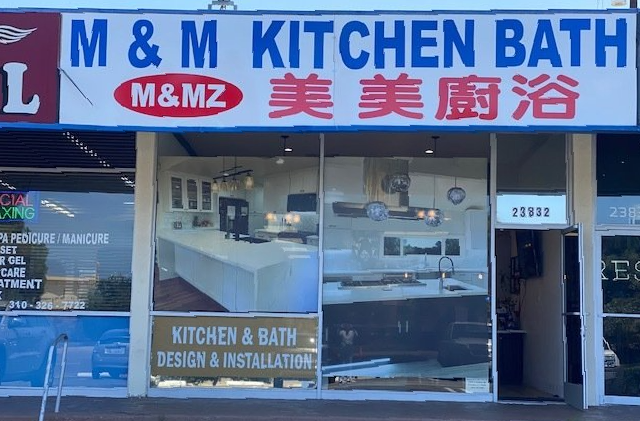 M & M Kitchen Bath storefront. Sign with English and Chinese text. Display windows showcase kitchen and bath design.