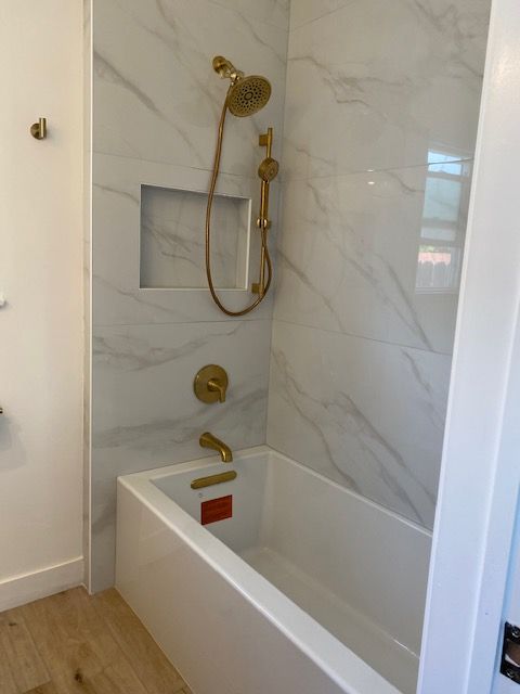 Bathtub and gold shower faucets