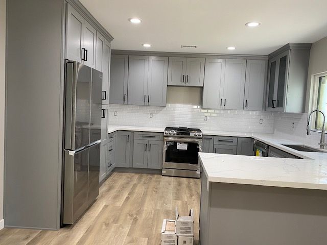Kitchen with gray cabinets and stainless steel appliances