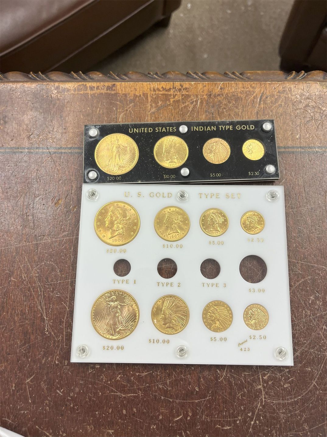 Gold coin display case showing various US gold coins.
