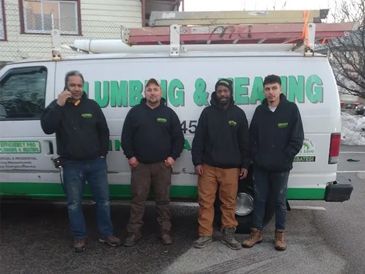 Four men standing in front of a plumbing and sealing van