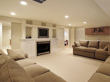 A living room with a couch, fireplace, and television.