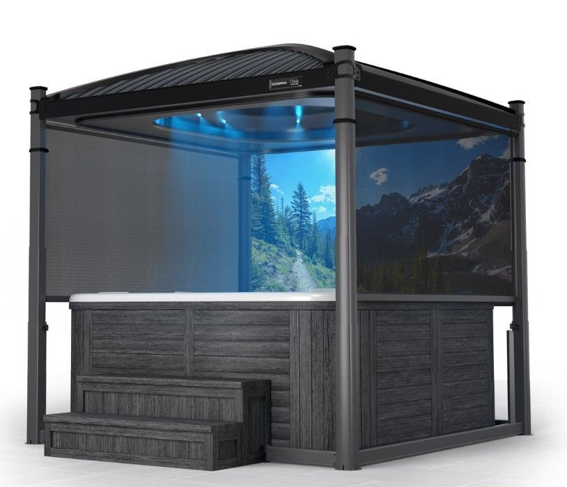 Hot tub enclosed in a dark gray gazebo with blue lights and mountain scenery on screens.