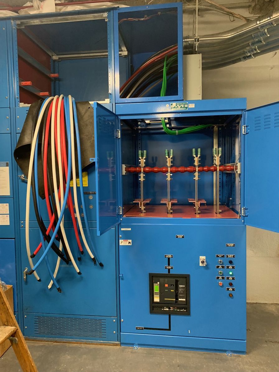 A blue cabinet with a bunch of wires hanging out of it