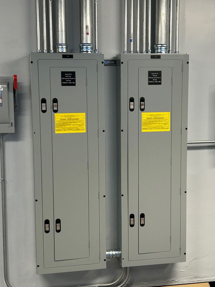 Two electrical panels with yellow stickers on them