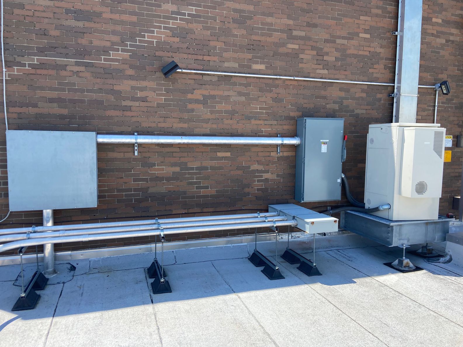 A brick building with a lot of wires coming out of it