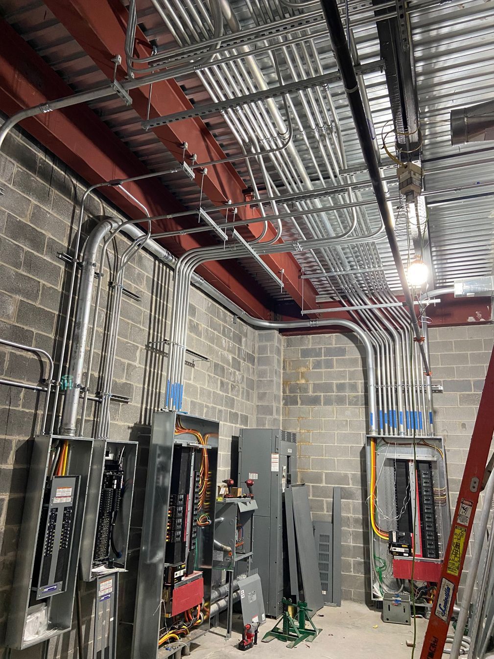 A room with a lot of electrical wires hanging from the ceiling