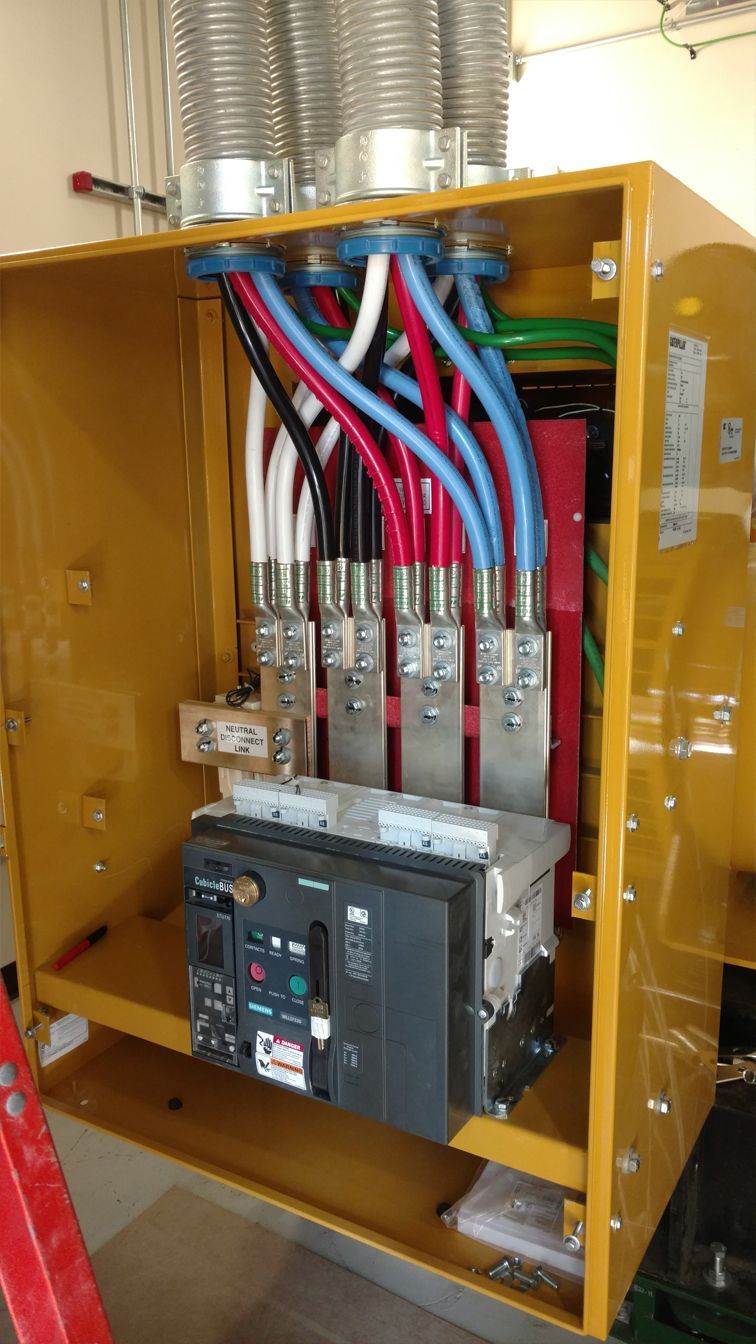 A yellow box with a lot of wires coming out of it