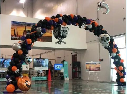A large arch made of balloons with skulls and pumpkins on it