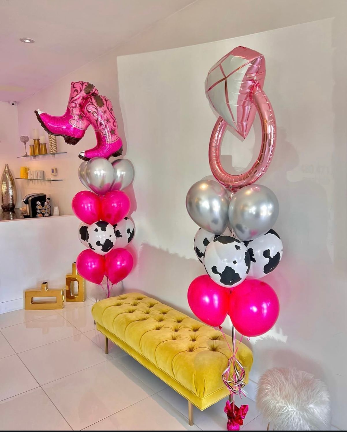 A room filled with balloons and a yellow bench