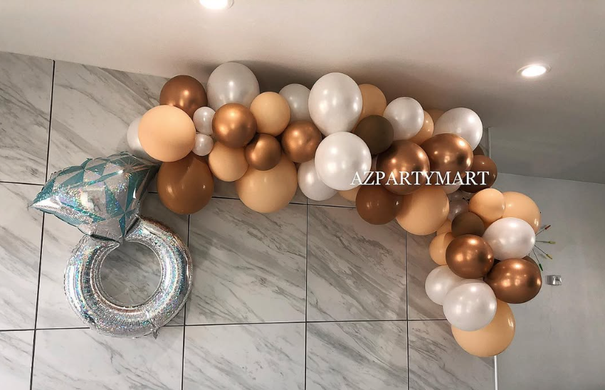 A bunch of balloons are hanging on a wall