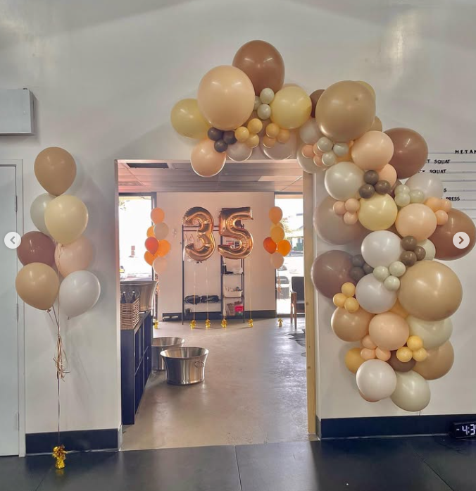 A room with balloons and a sign that says 35