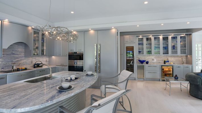 A kitchen with granite counter tops and stainless steel appliances