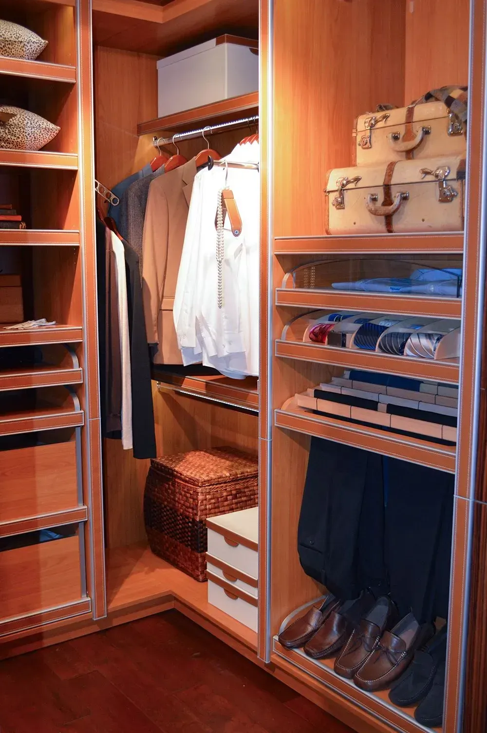 A walk in closet filled with clothes and shoes.