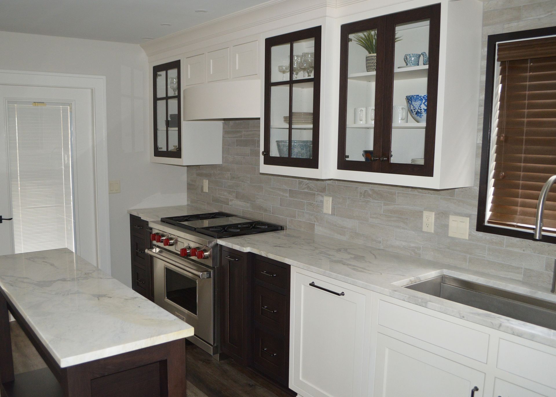 A kitchen with white cabinets and stainless steel appliances.