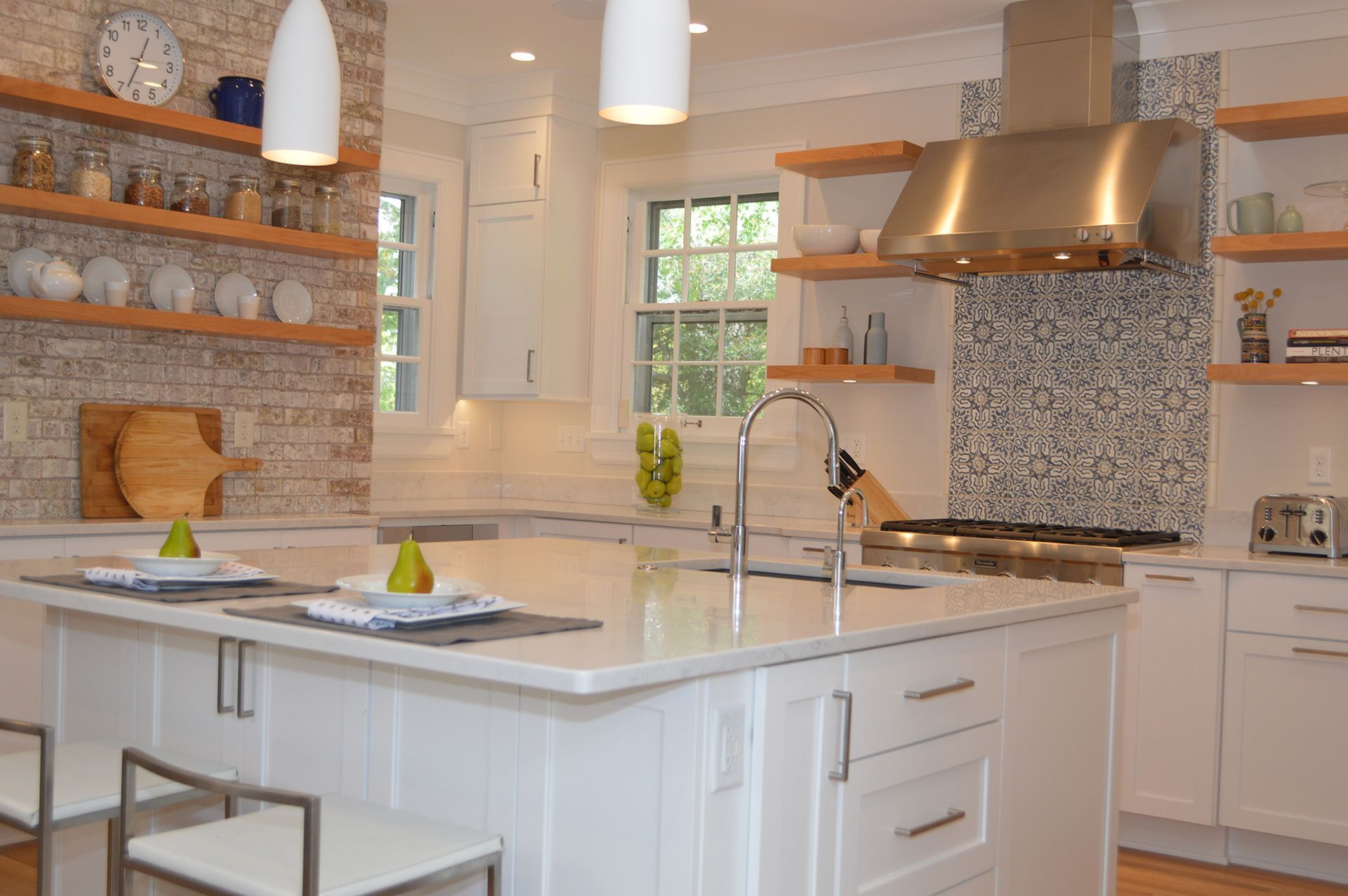 A kitchen with white cabinets and stainless steel appliances.