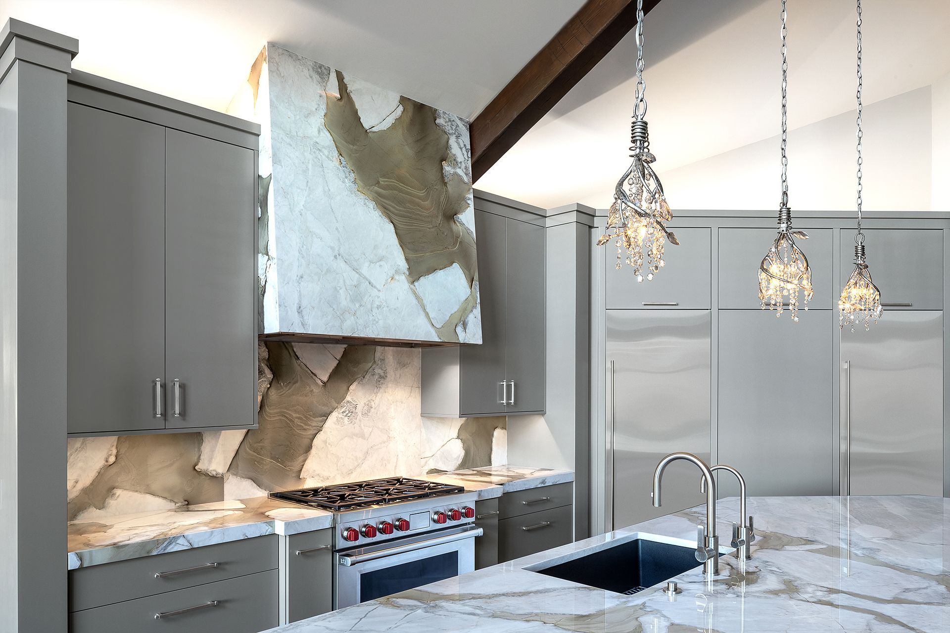 A kitchen with a stove top oven and a sink.