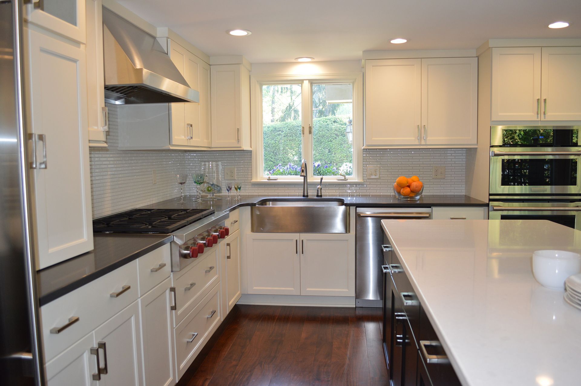 A kitchen with white cabinets and stainless steel appliances.