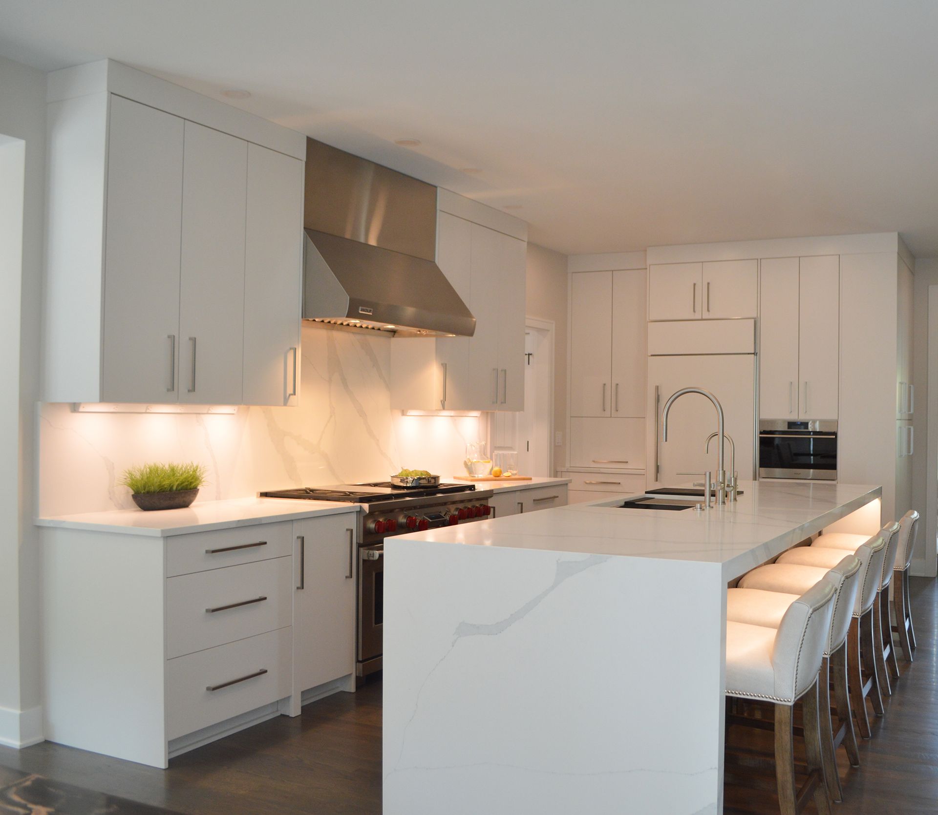 A kitchen with white cabinets and stainless steel appliances.