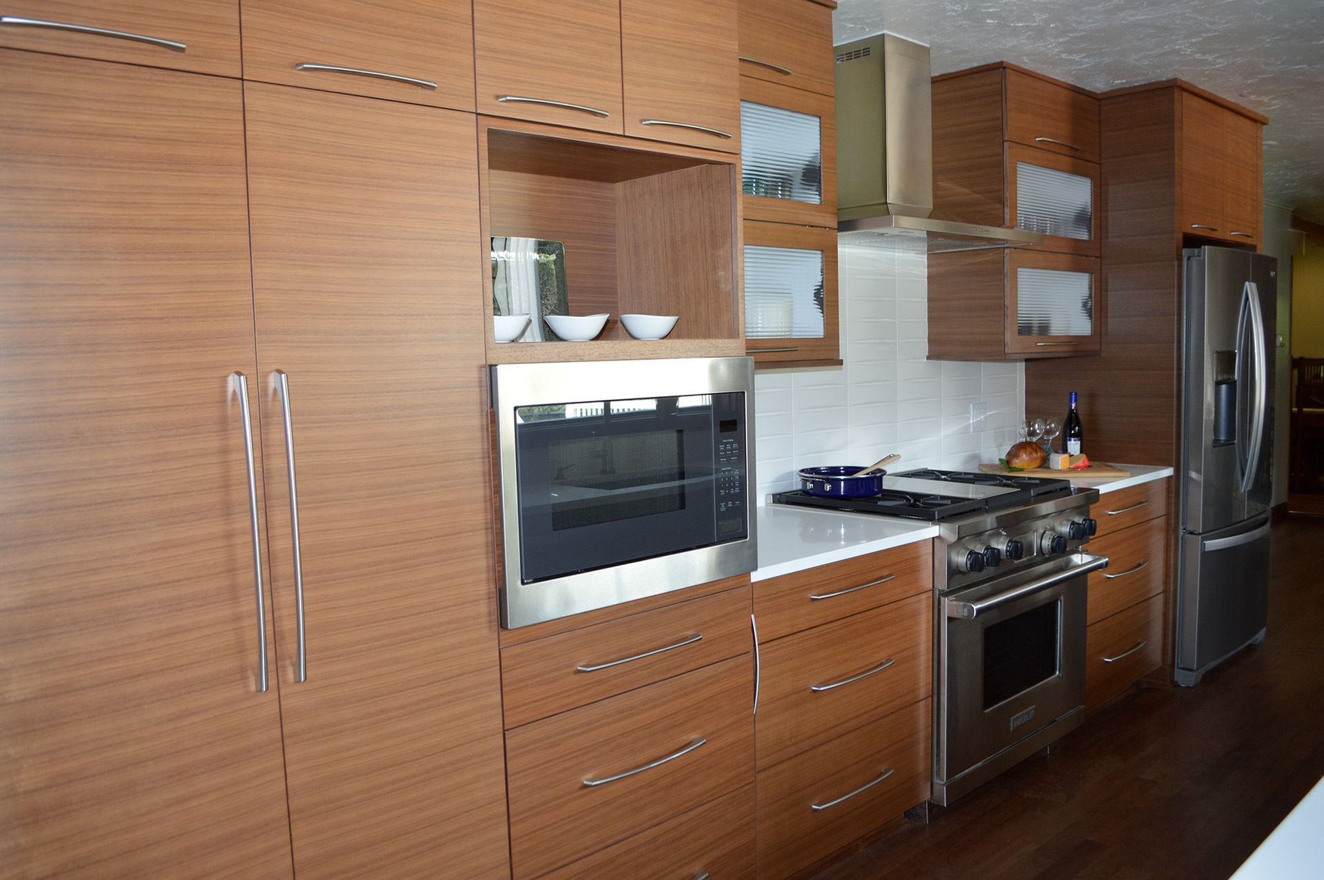 A kitchen with wooden cabinets and stainless steel appliances