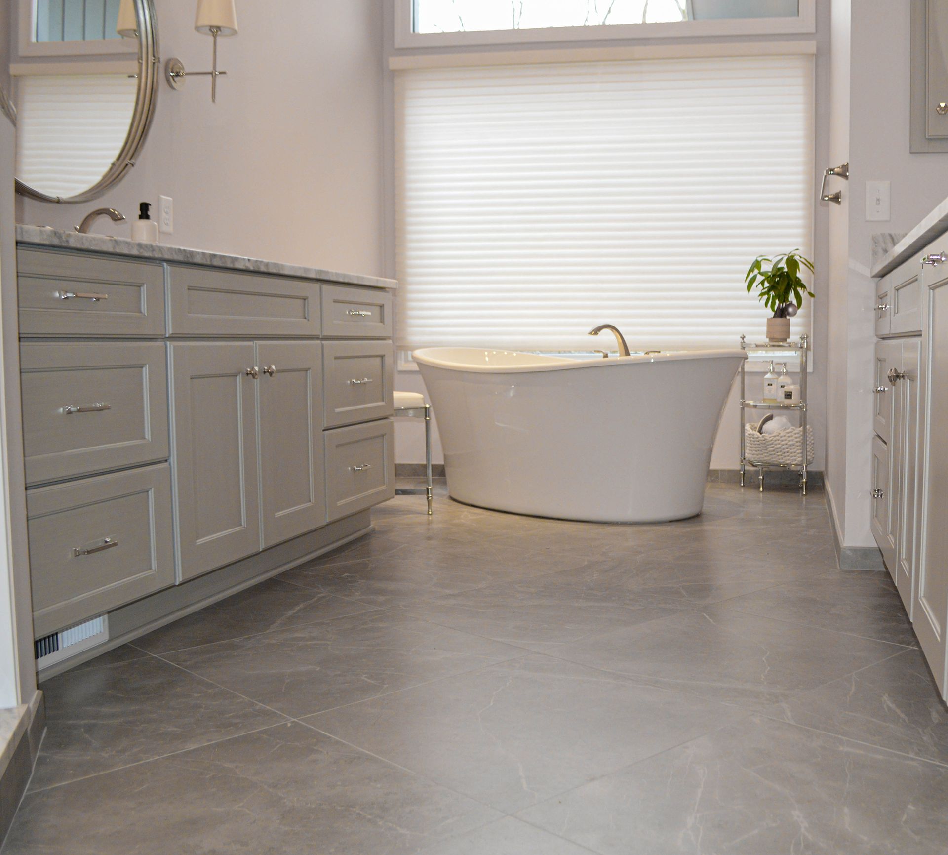 A bathroom with a tub, sink, and mirror.