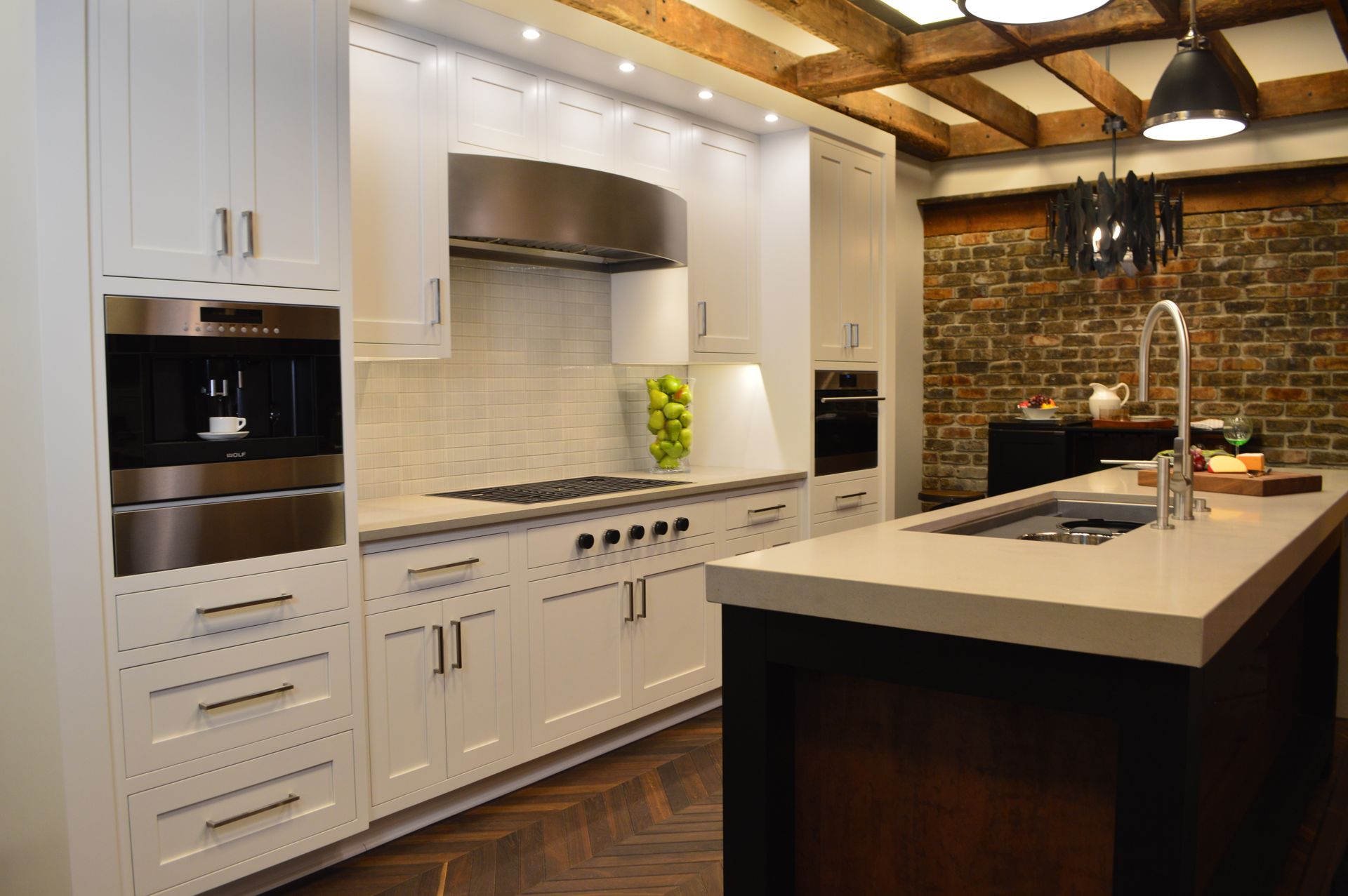 A kitchen with white cabinets and stainless steel appliances
