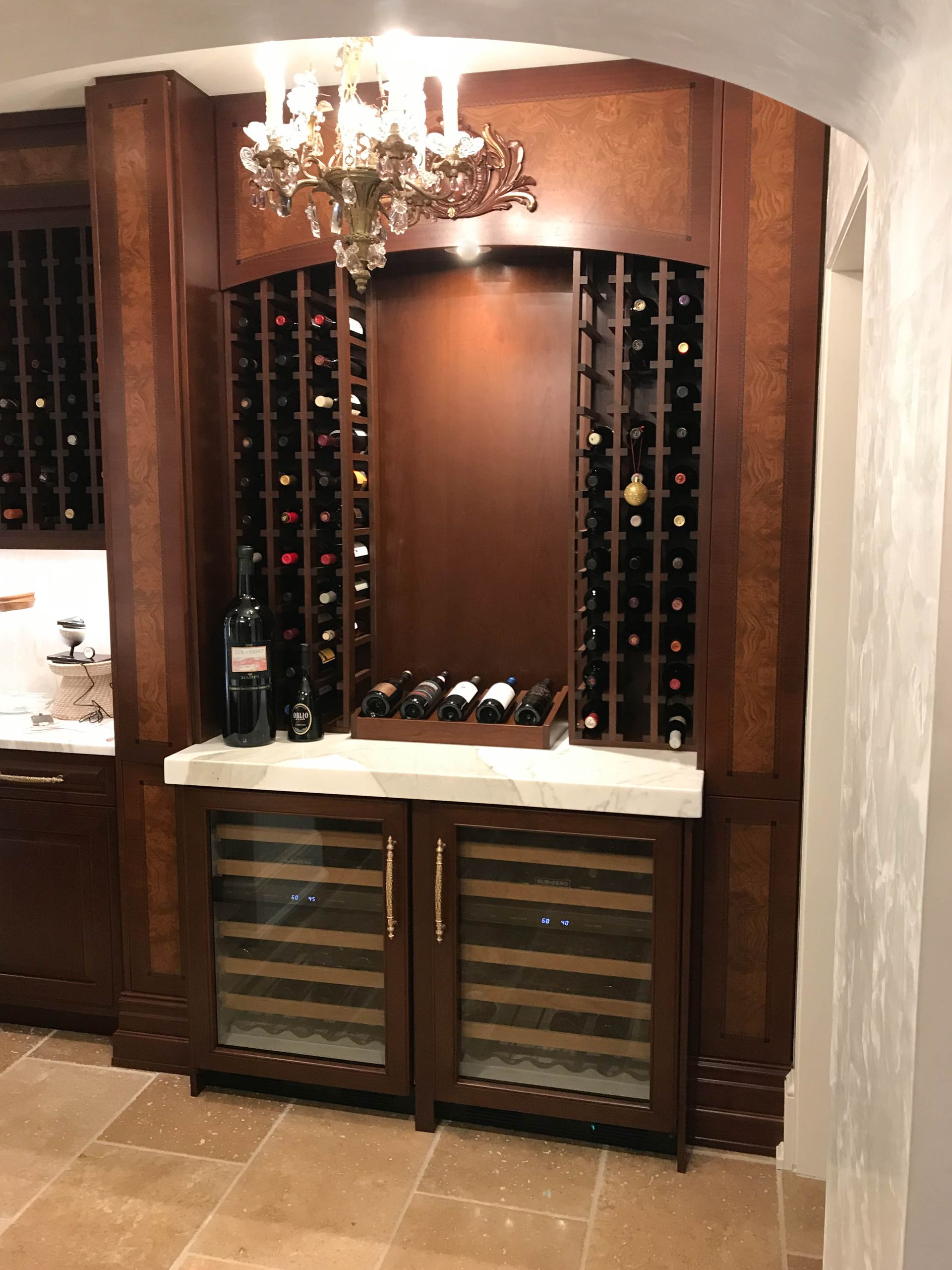 A wine cellar with lots of wine bottles and a refrigerator