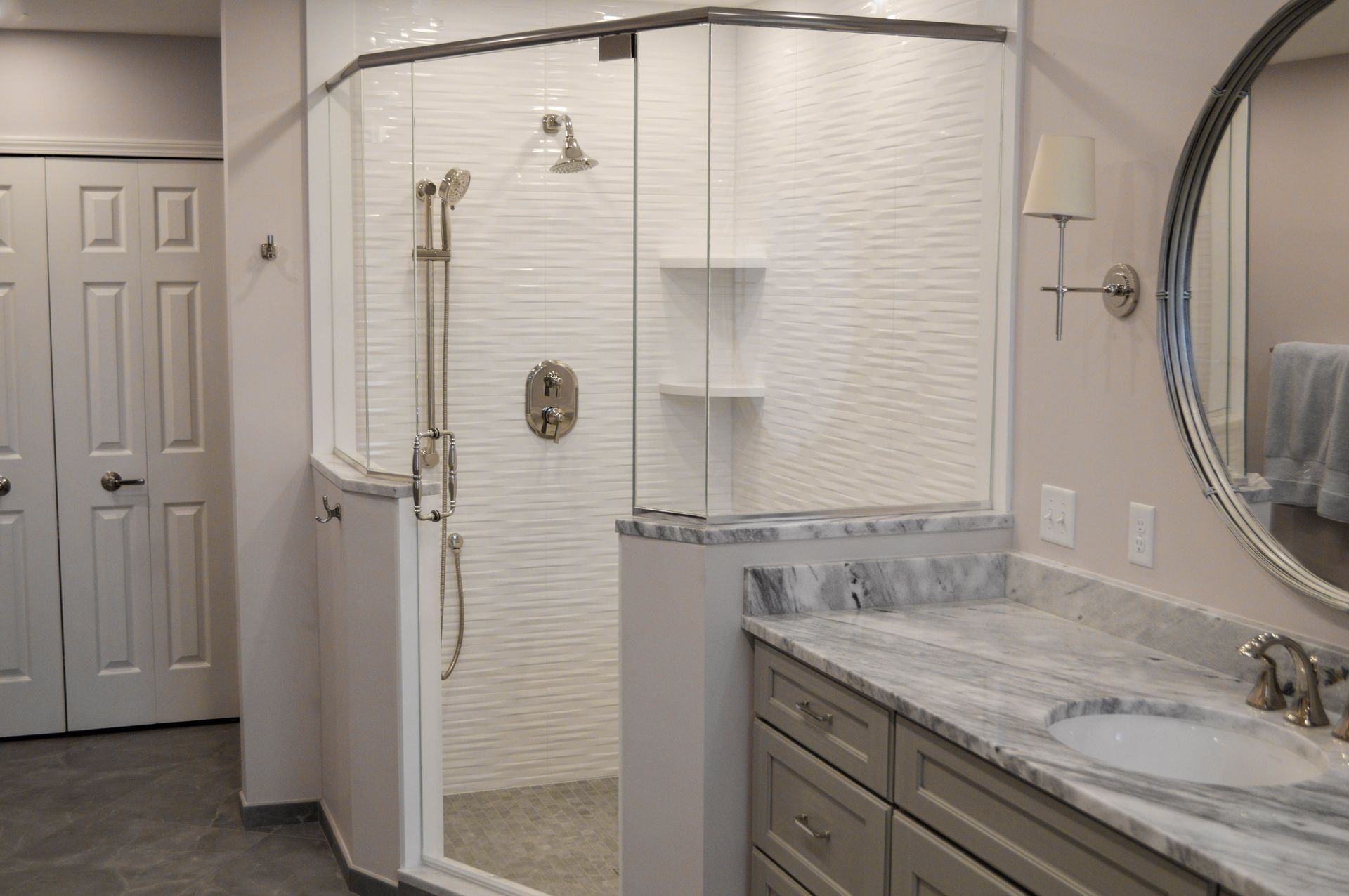 A bathroom with a walk in shower , sink and mirror.
