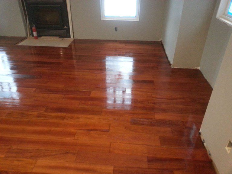 A living room with hardwood floors and a fireplace