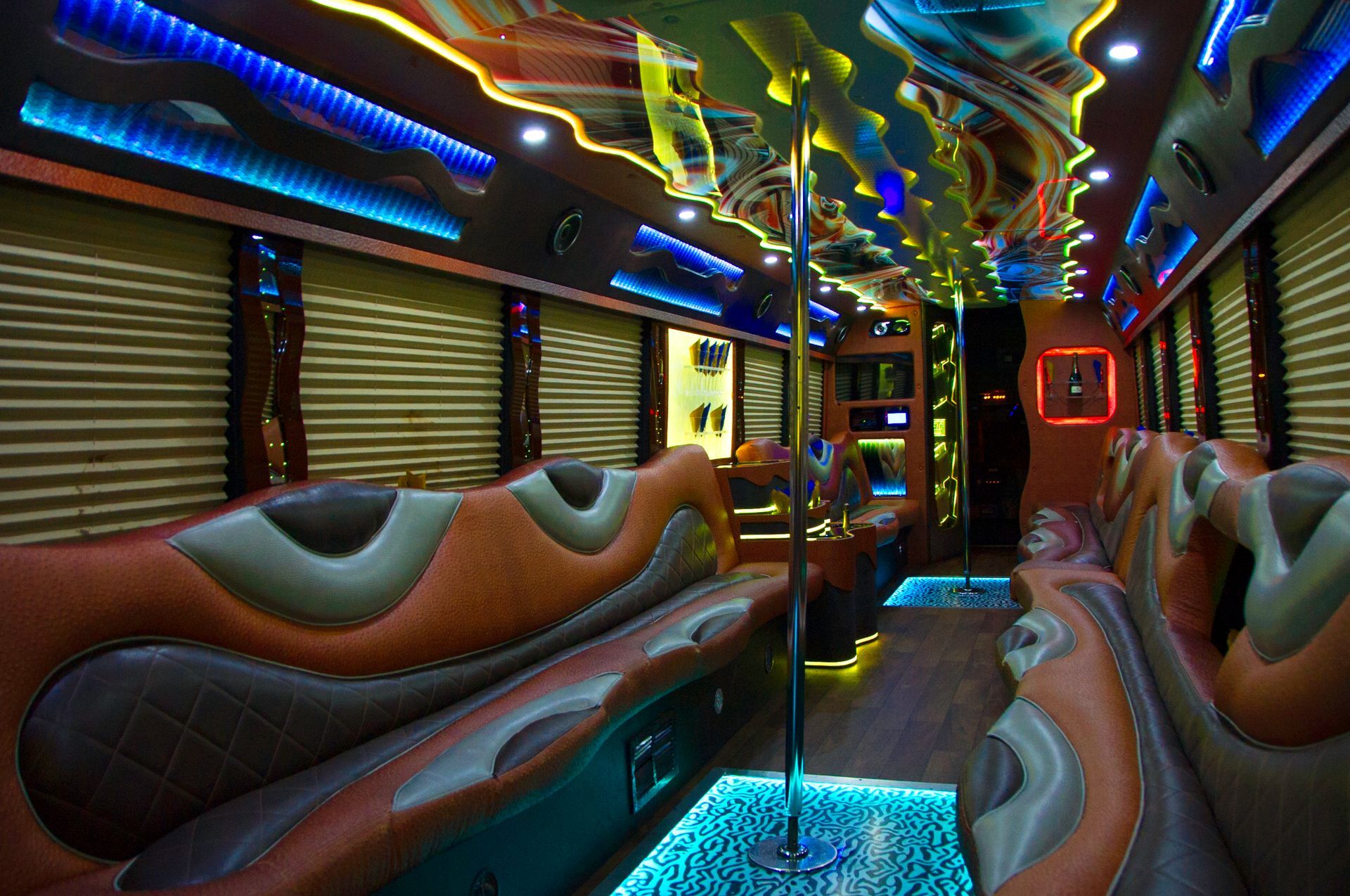 Empty luxury bus interior with colorful LED lighting and upholstered seats