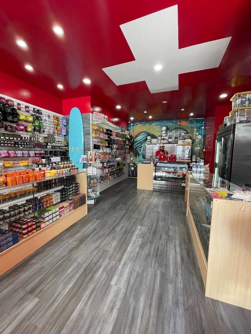 A store with a red ceiling and a white cross on the ceiling.
