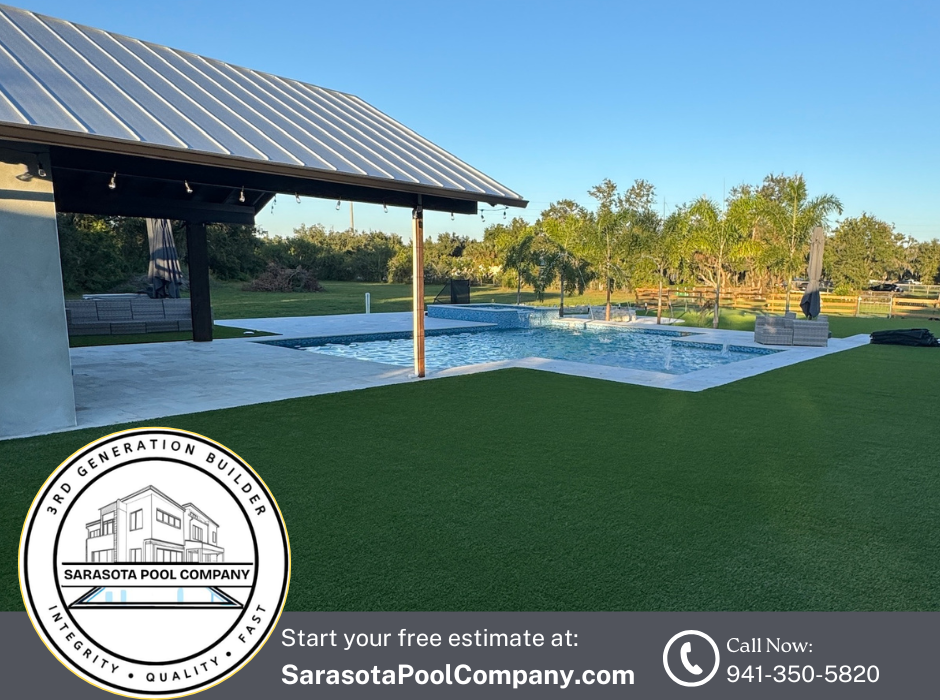 Poolside patio with covered seating, white fence, green lawn, palm trees, and sunset sky.