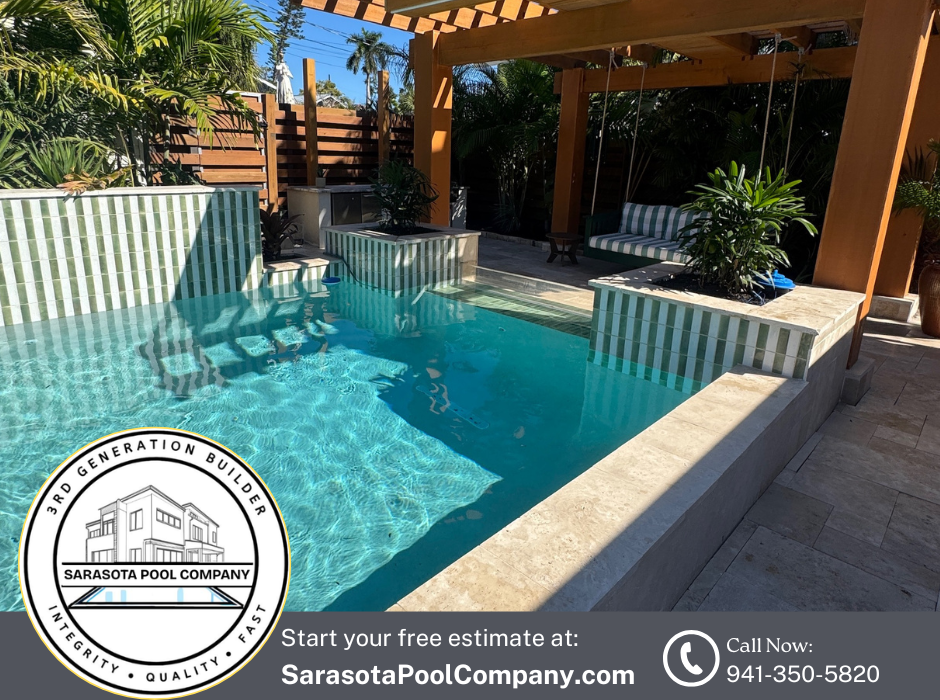 Turquoise pool with wood pergola, tiled waterfall wall, and tropical landscaping in a sunny backyard.