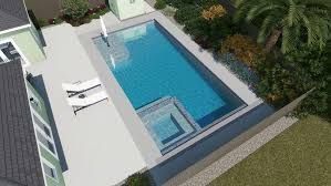 Modern patio with a rectangular blue swimming pool, spa, lounge chairs, and surrounding greenery.