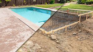 Backyard swimming pool with a concrete patio and a fenced dirt construction area beside it