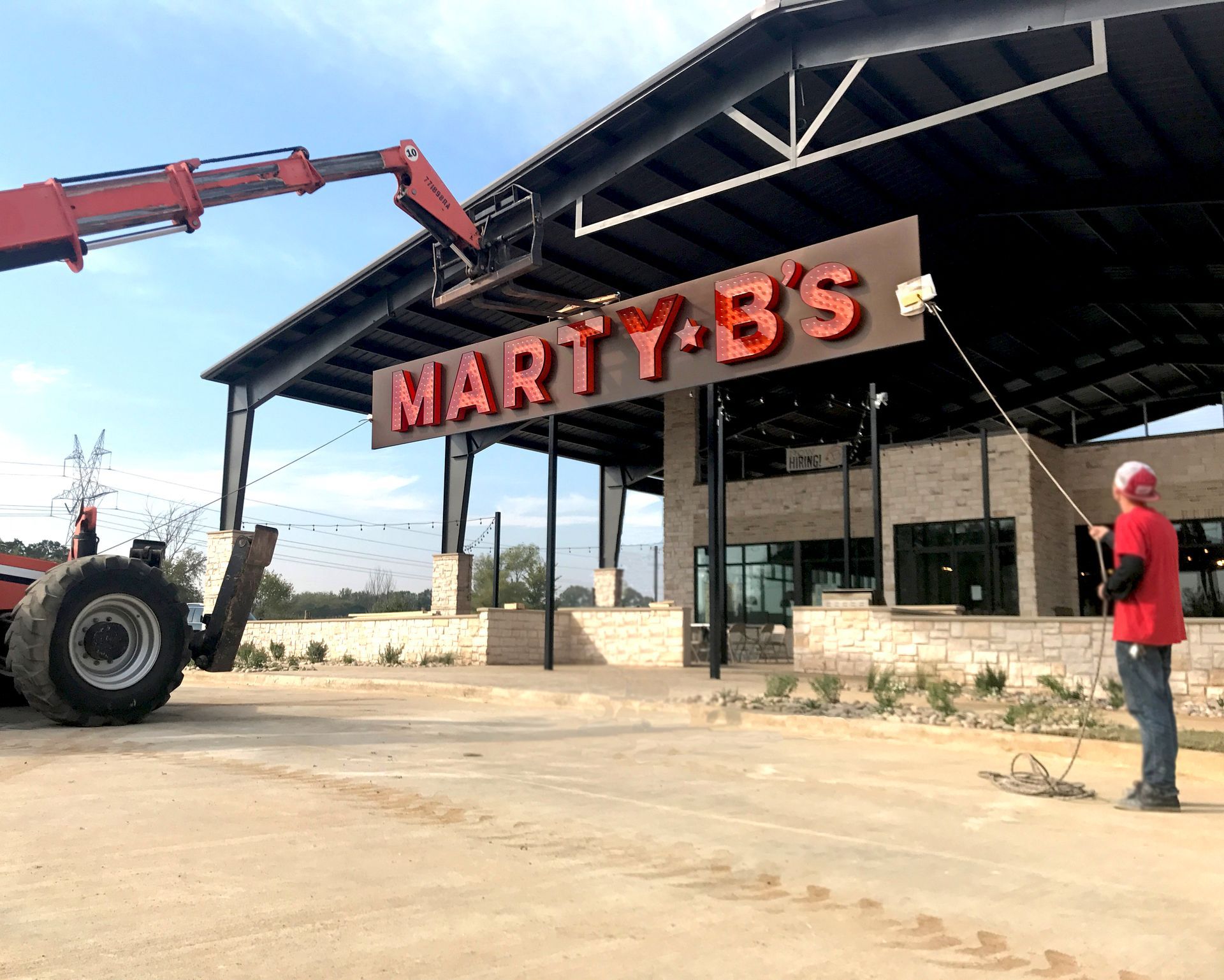 Exposed bulb front lit channel letter sign on backplate being installed at Marty B's Restaurant in Bartonville, TX