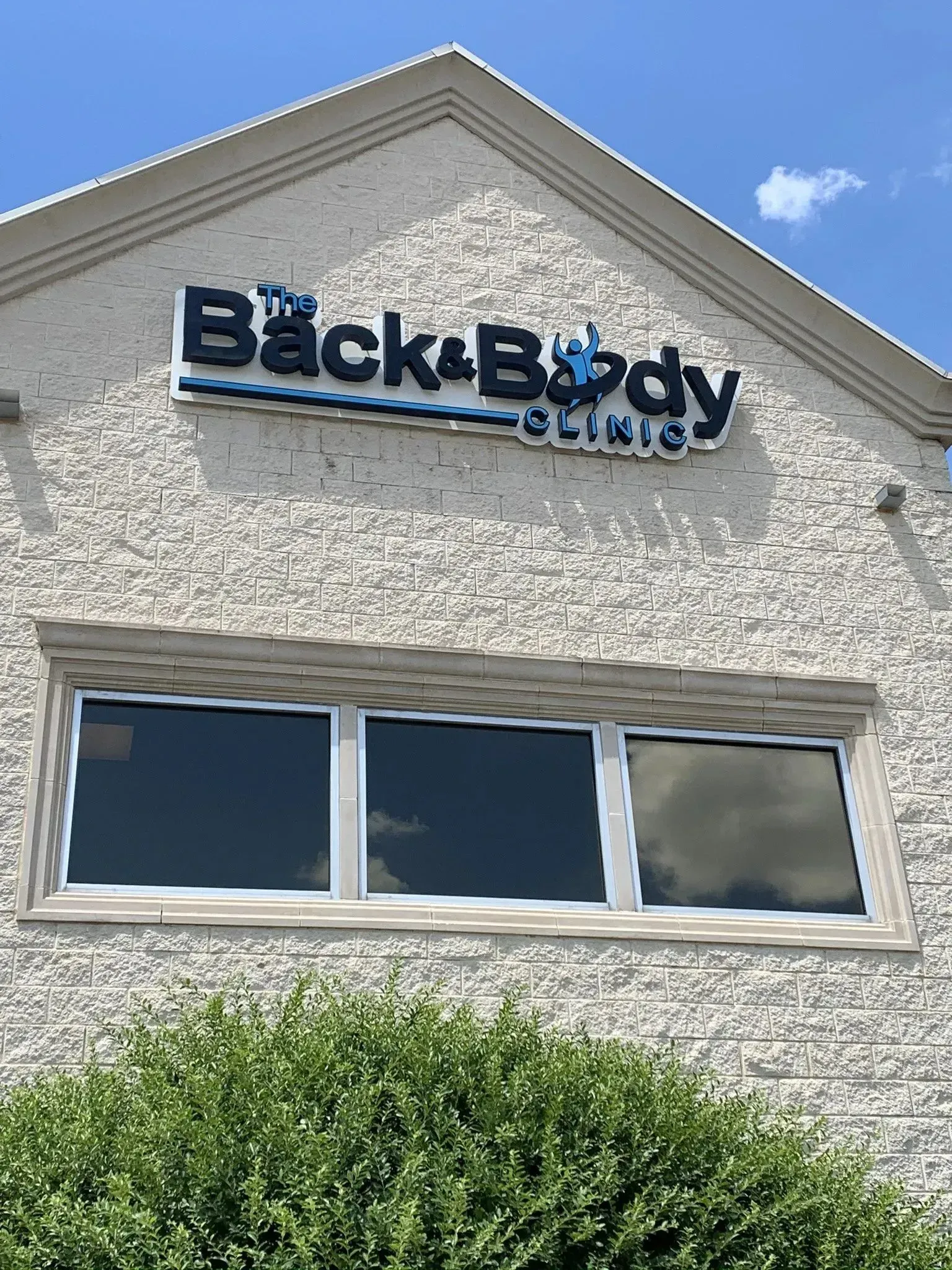 Front-lit channel letter building sign installed for Back & Body in Lewisville, TX