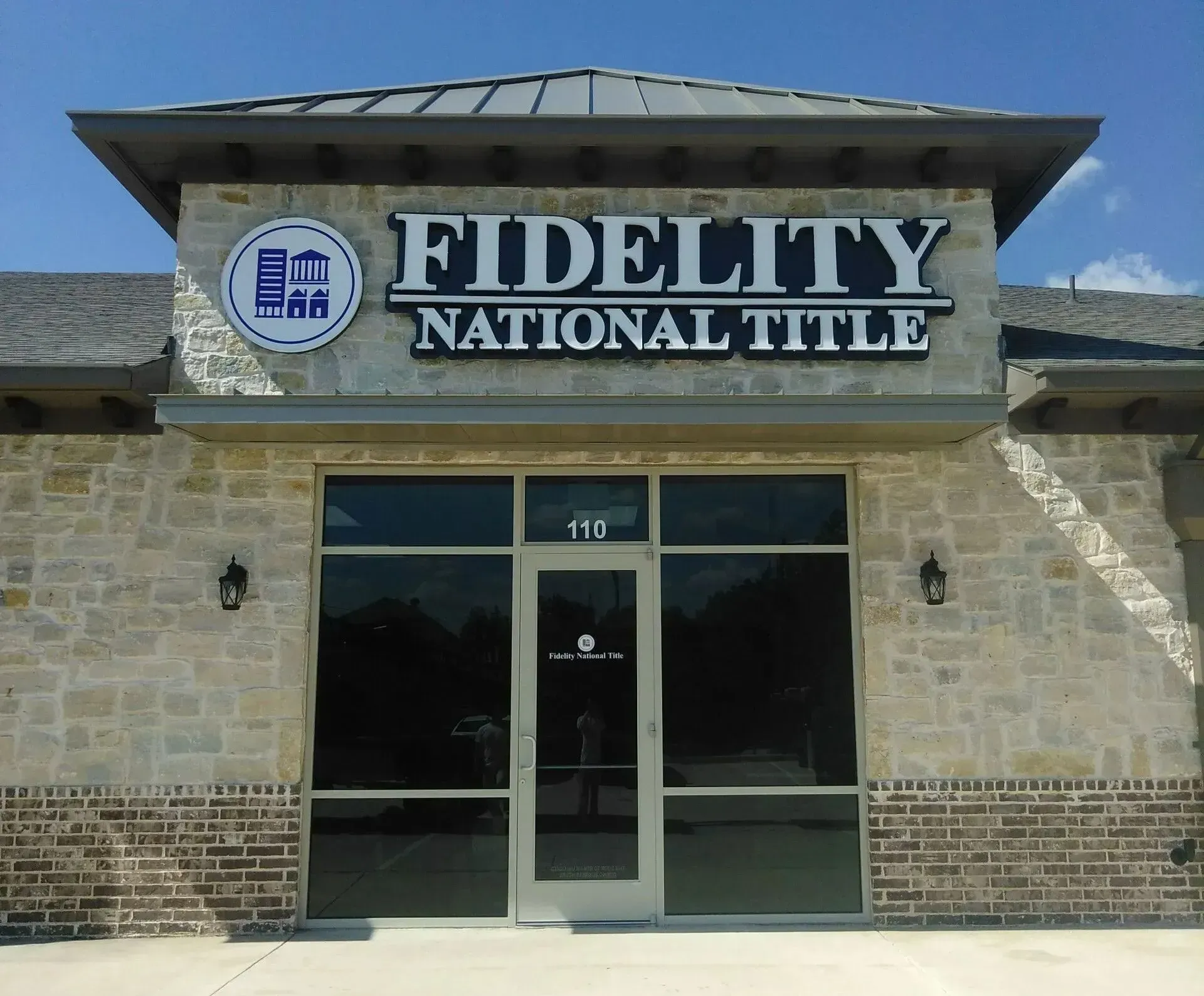 Front lit channel letter building sign and logo fabricated and installed for Fidelity National Title in Flower Mound, TX