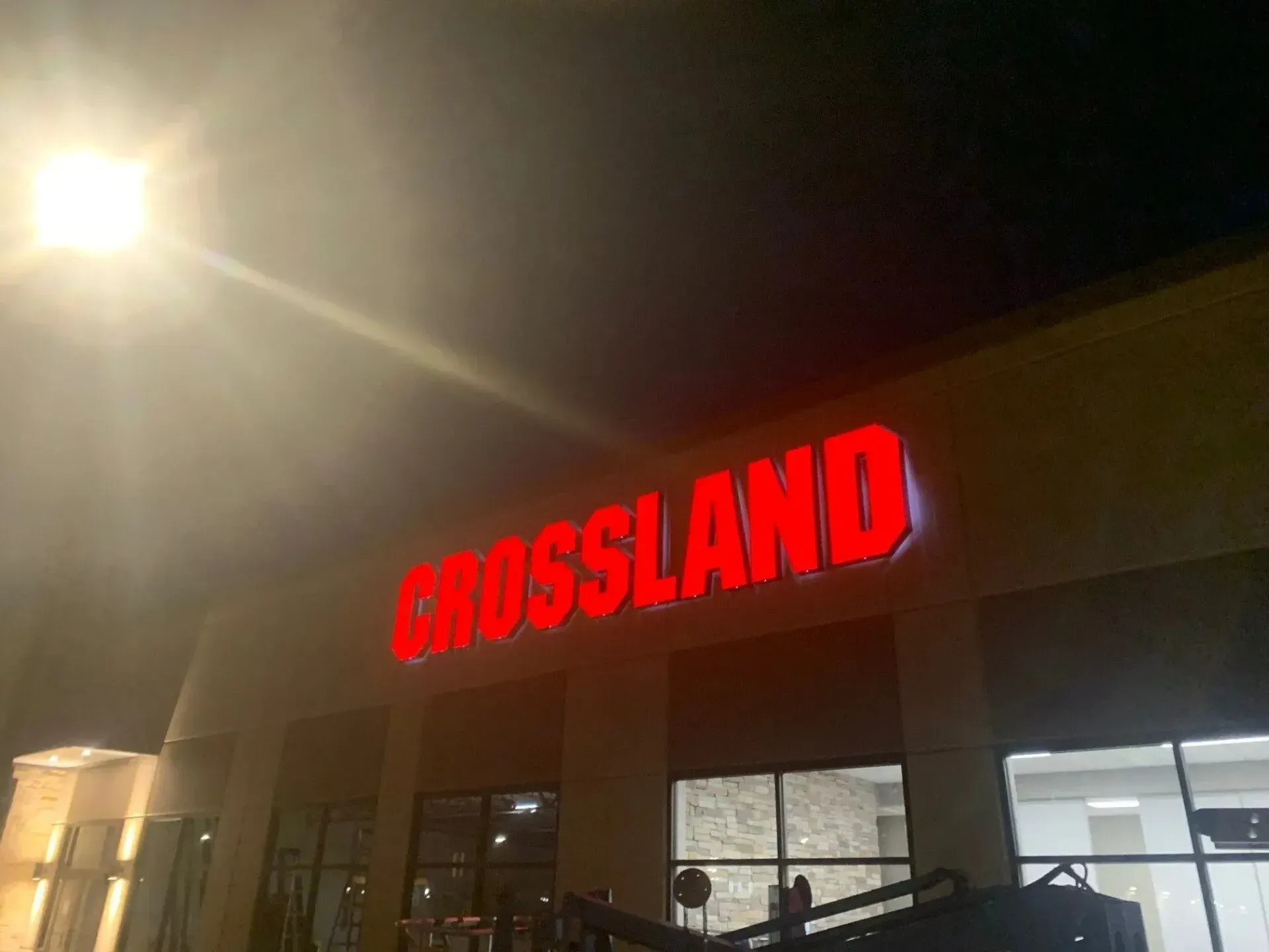 Front lit channel letter building sign with red translucent faces fabricated and installed for Crossland Construction in Prosper, TX