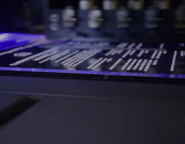 a close up of a computer keyboard with a blue light behind it